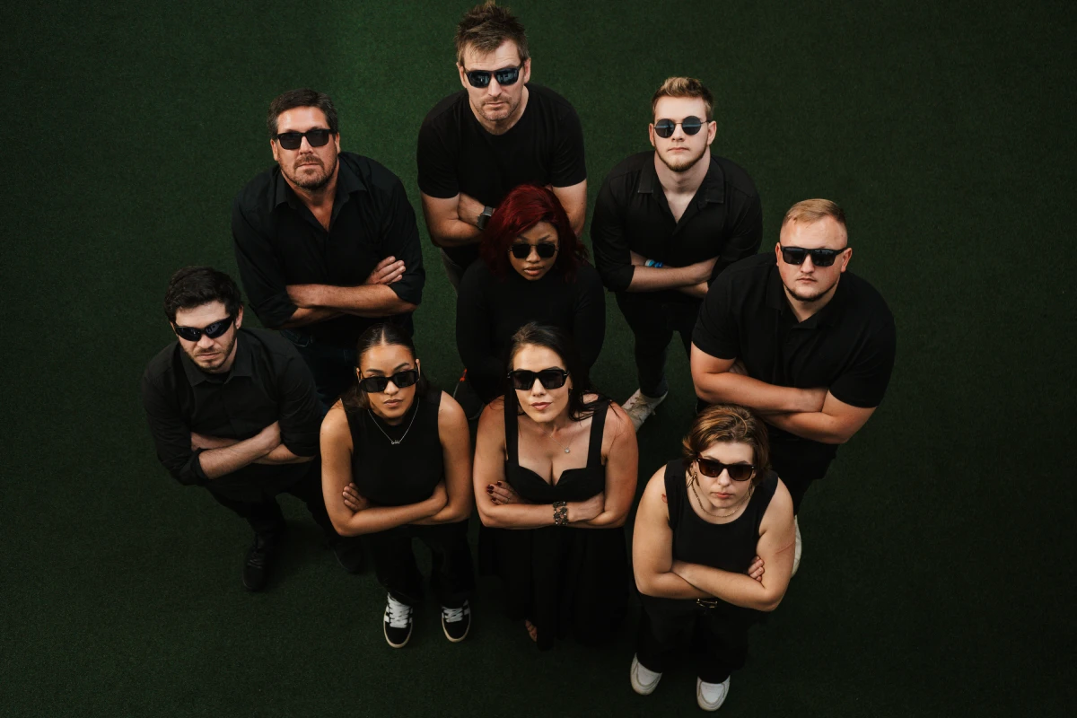 Kickass Collective digital marketing team dressed in black, looking up at camera. Bold agency photo in Gauteng